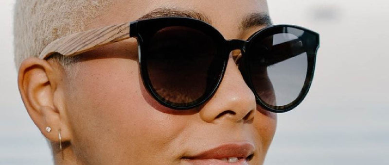 Man wearing blue mirror sunglasses on a blue sky background