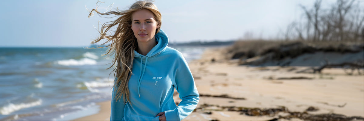 Woman on the beach in Eco Beach hoodie