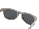 Gray sunglasses with dark lenses on a white background