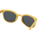 Yellow sunglasses with dark lenses on a white background