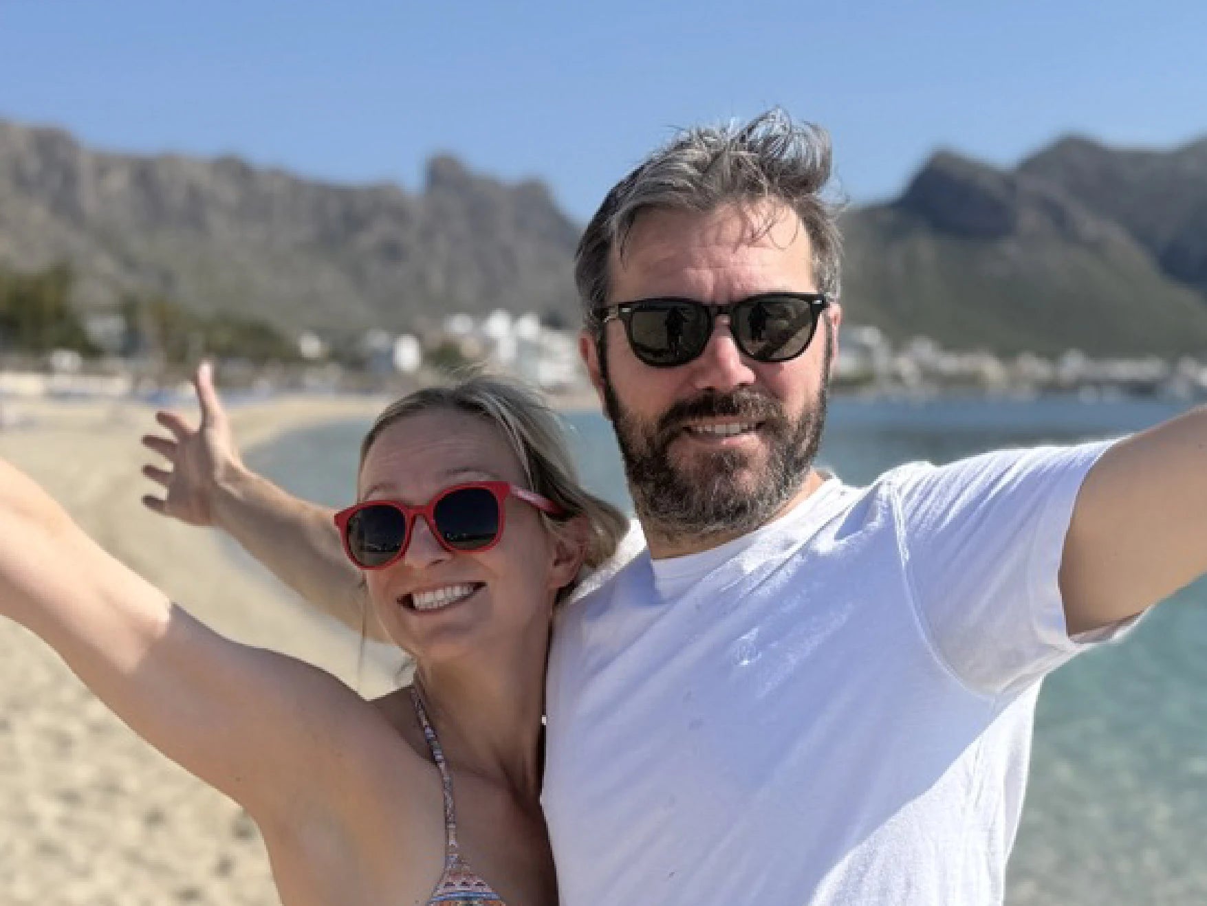 Couple on a beach with mountains in the background