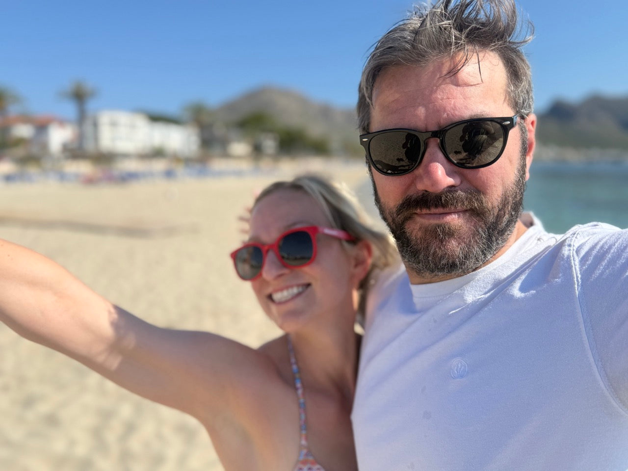Man and woman on the beach in Eco Beach Sunnies