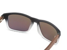 Sunglasses with brown gradient lenses and wooden arms on a white background
