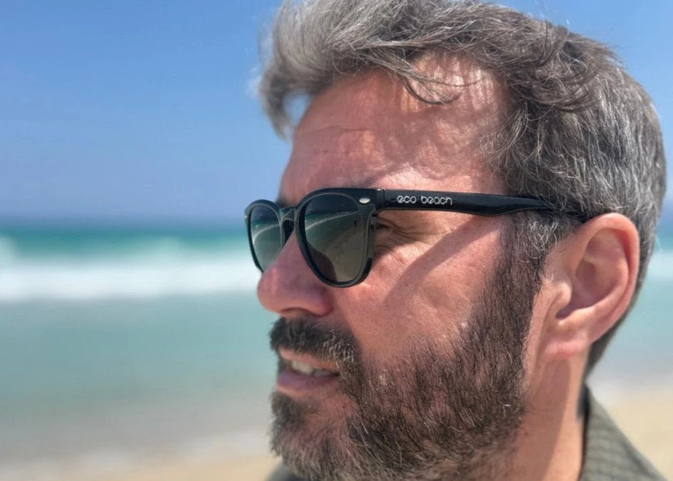 Man wearing Benone sunglasses with a beach in the background
