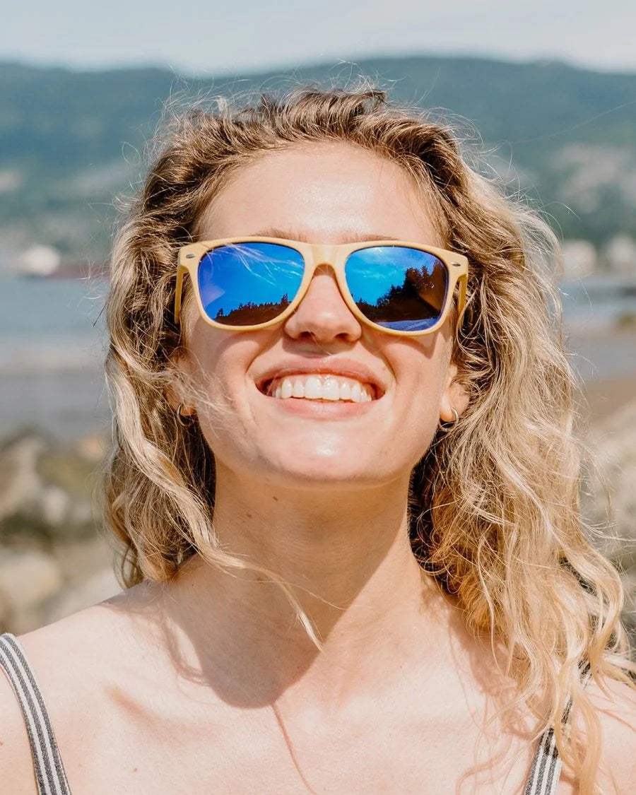 Woman wearing sunglasses with a mountainous background