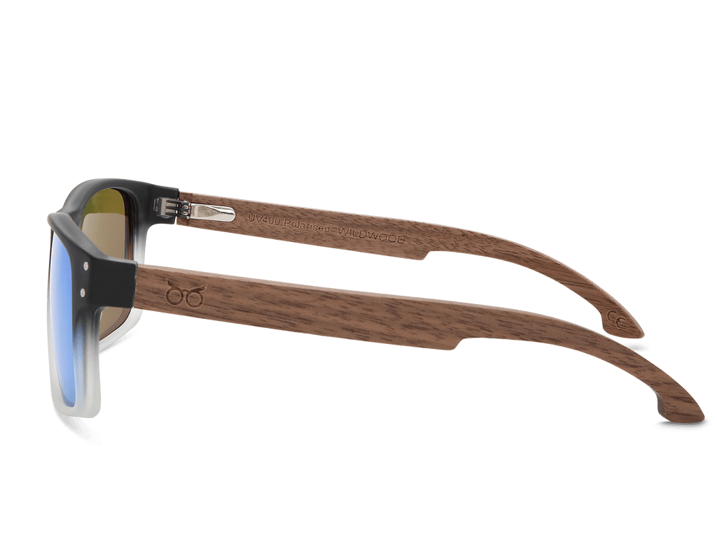Sunglasses with wooden frame and reflective lenses on a white background