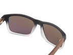 Sunglasses with brown gradient lenses and wooden arms on a white background