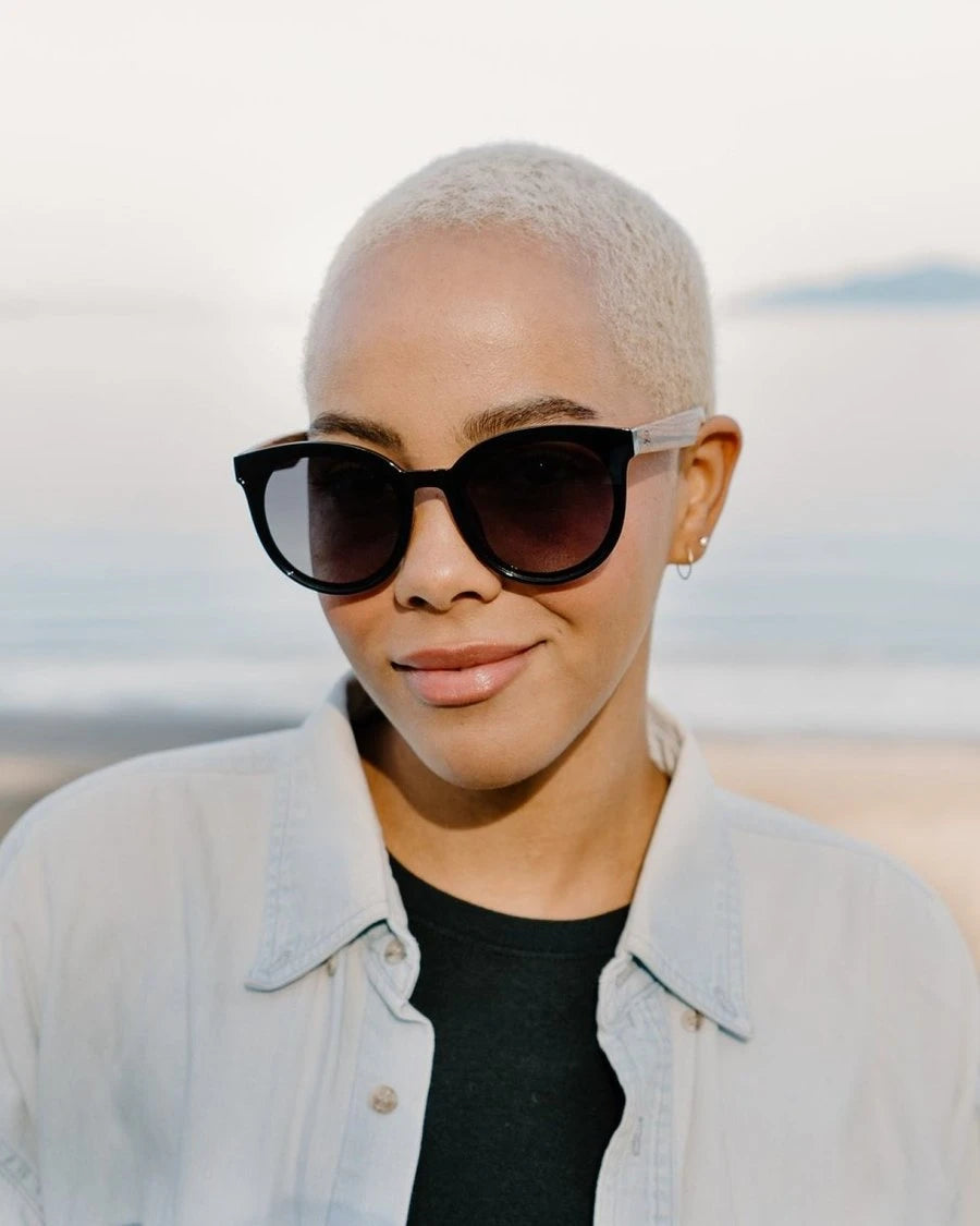 Woman wearing Santorini sunglasses with a blurred background