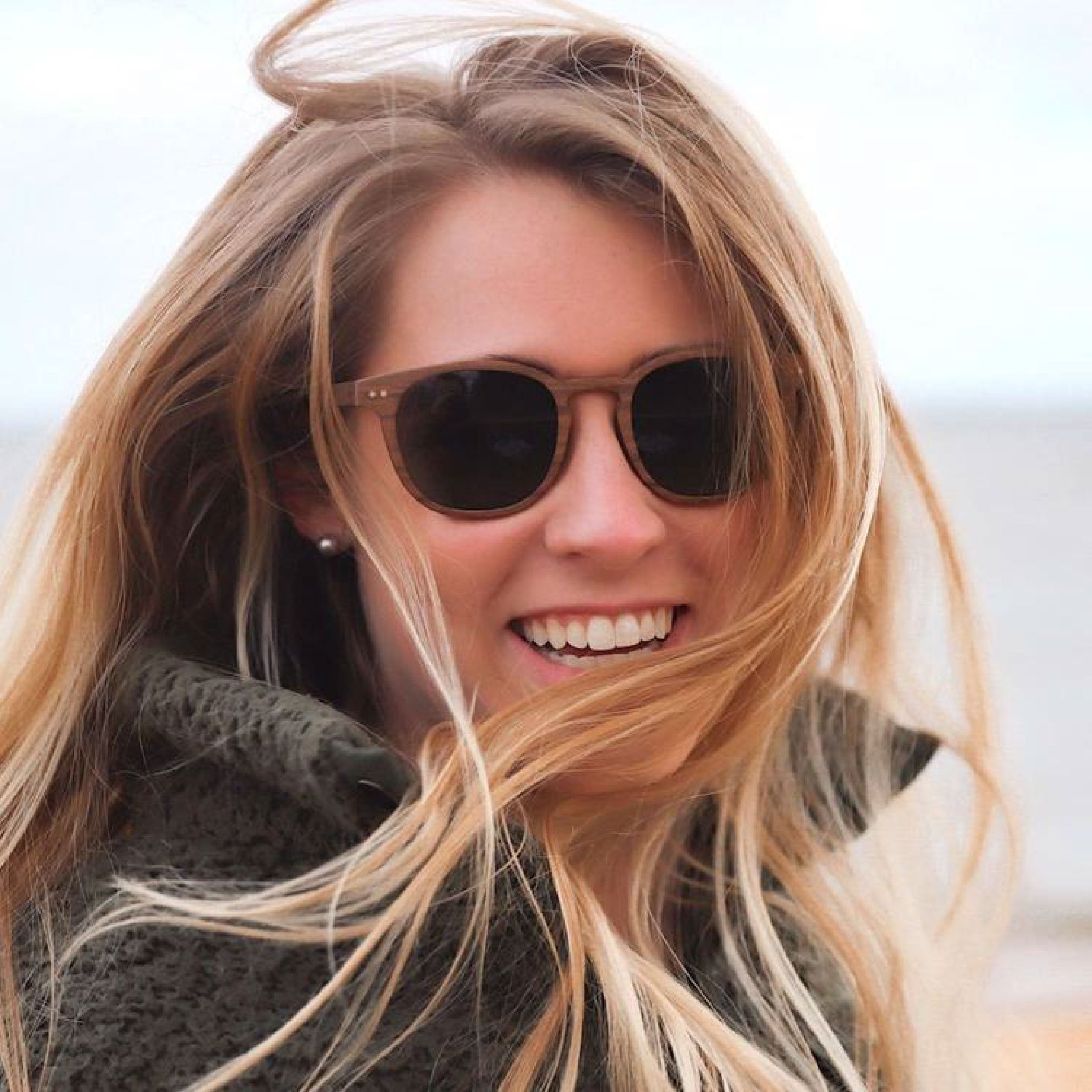 Woman in Wildwood wooden sunglasses