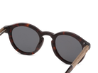 Sunglasses with tortoiseshell frame and dark lenses on a white background