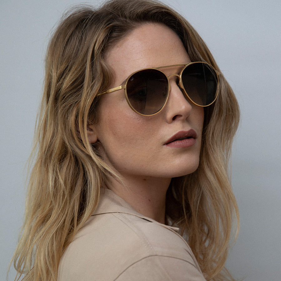 Woman wearing large aviator sunglasses with polarised lenses